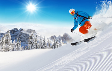 Skier on piste running downhill