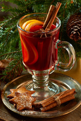 Mulled wine with cinnamon sticks,  ginger cookies and spruce branches