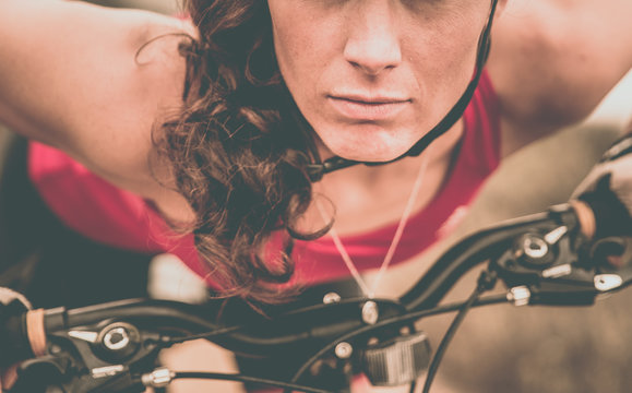 Focused woman riding on her bicycle. Downhill and mountain bike