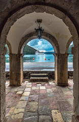 View through museum archway in the old town Perast