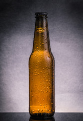 fresh cold beer ale bottle with drops and stopper