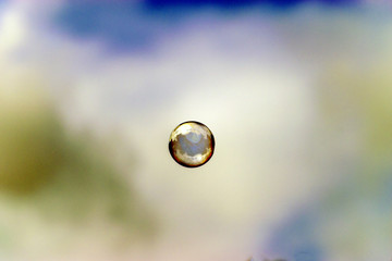 Soap bubble floating in sky background