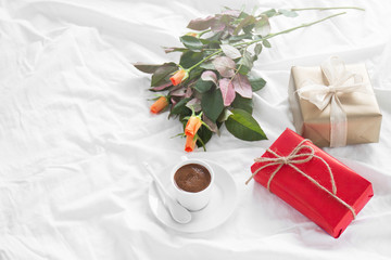 Fototapeta na wymiar Romantic breakfast with coffee, chocolate pralines, gift box and