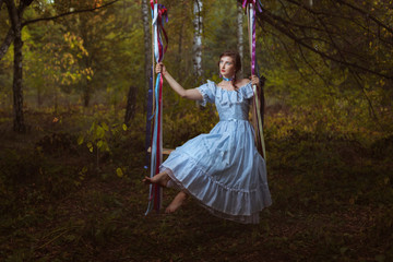 Girl swinging on a swing.