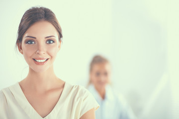 Obraz premium Attractive businesswoman sitting on desk in the office