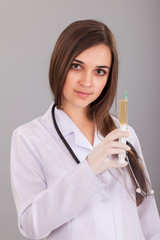 Woman doctor holding a filled syringe