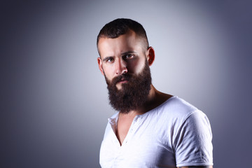 Obraz premium Portrait of handsome man standing, isolated on grey background