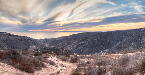 Laguna Canyon Road leading to the ocean from Top of the World hiking trail in Laguna Beach at sunset © SailingAway