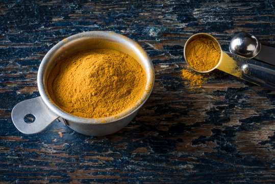 Ground Turmeric in a Measuring Cup