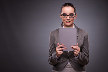 Young woman with tablet in business concept