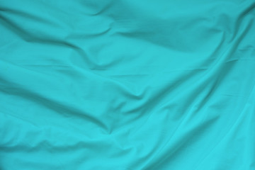 Creased blue cloth material fragment as a background