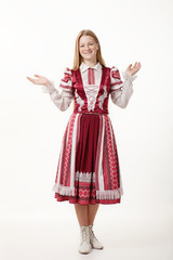 Young beautiful redhead woman dancer in traditional folk costume posing isolated on white background