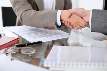 Business handshake. Two women lawyers are shaking hands after meeting or  negotiation.