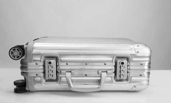 suitcase lay on white trable ready to open