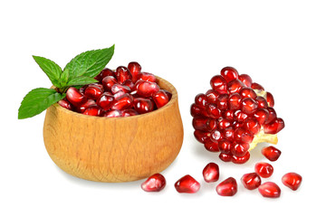 Pomegranate seeds in a wooden bowl isolated on white background