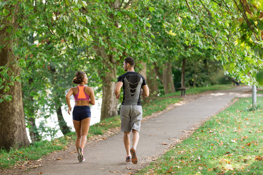 Young couple running in early morning at the park