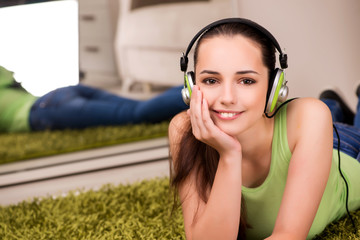 Young woman listening to music at home