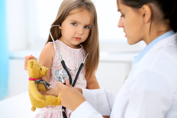 Happy little girl at  health exam at doctor's office