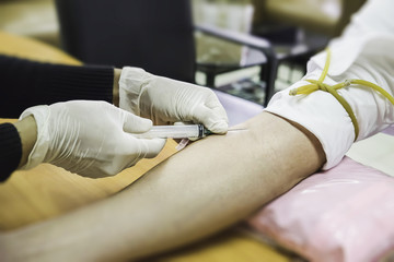 Nurse collecting a blood from a patient