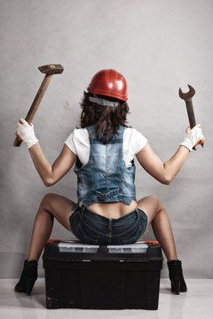 Sexy girl mechanic working with tools. Back.