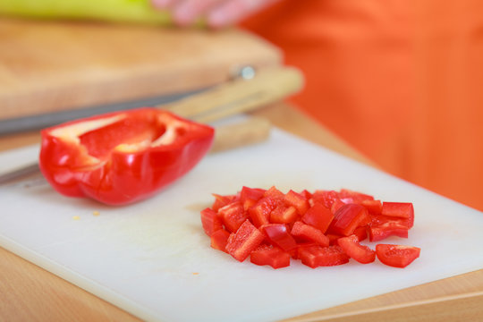 Red sliced pepper with knife on cutting board