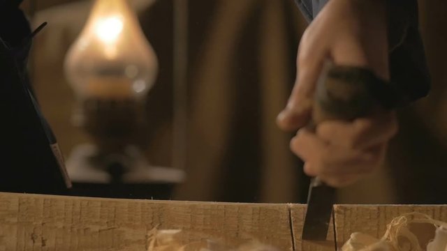 master carpenter makes basting on the Board with a pencil, draws, craftsman work tool in the workshop.