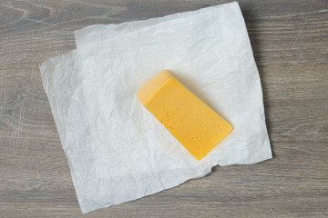 Cut of cheese on wooden table