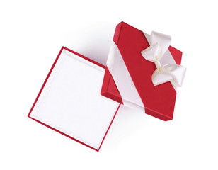 Top view of open red gift box with white satin ribbon and bow isolated on white background