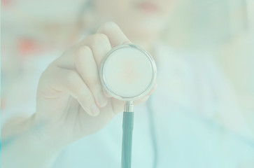 female doctor in white uniform holding stethoscope