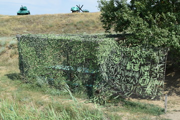 Camouflage Cape canopy over the gazebo and bench