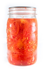 Fototapeta na wymiar Jar of home canned tomatoes isolated on white