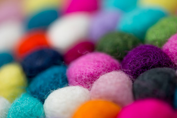 Colorful balls of wool. Colorful felt balls. Dried balls of wool. Colored beads. Felt handmade. Potholder with colorful beads.