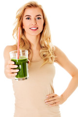 Young woman drinking green cocktail