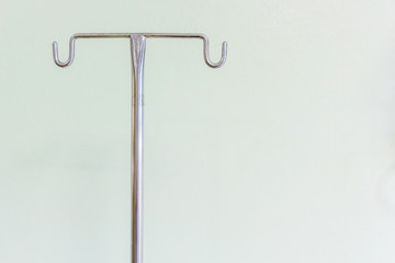Empty intravenous pole hanger for serum, blood and pharmaceutical bags in brightly lit hospital...