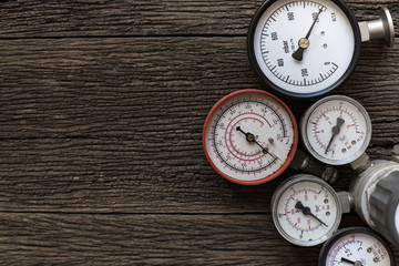 Old pressure gauge on wood table