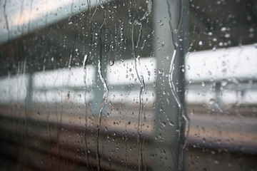 Rain drops on glass with a background.