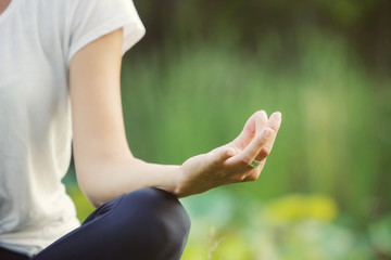 Young girl doing yoga in the park
