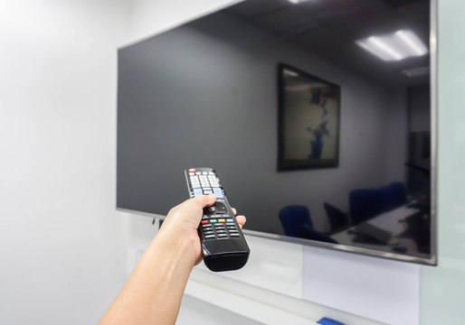 smart TV remote control in woman hand