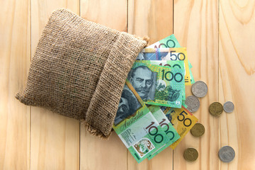 Money, Australian dollars (AUD), spilled out from a bag