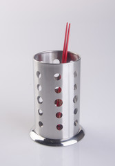 Kitchen utensils holder on background.