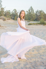 Fototapeta na wymiar Beautiful girl dancing on the beach.