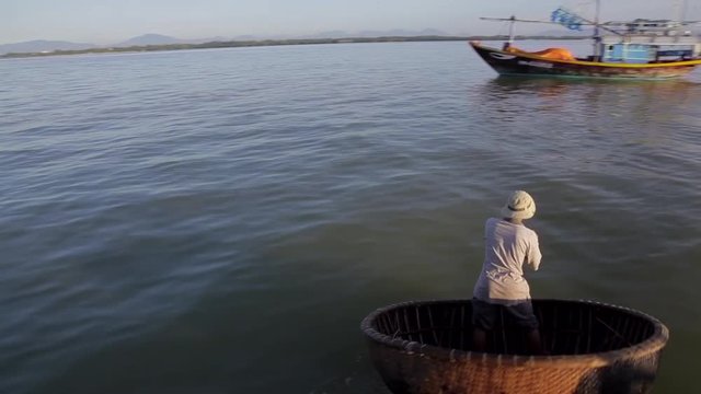 WS PAN Fisherman Rowing by in Traditional Round Boat / Hoi An, Vietnam