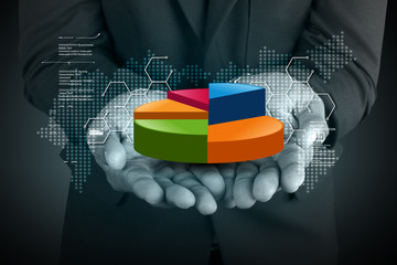 Business man showing pie chart in color background