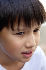 Portrait of a Boy with Dark Hair Outdoors