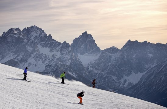 Skiers at the Elmo Mount ski area, Sesto Dolomites in the background, South Tyrol, Italy
