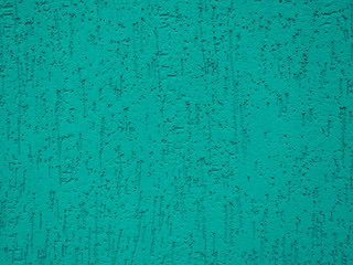 Fragment of the color bright plastered wall with a deep relief.