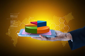 Fototapeta premium Business man showing pie chart with tablet computer in color background