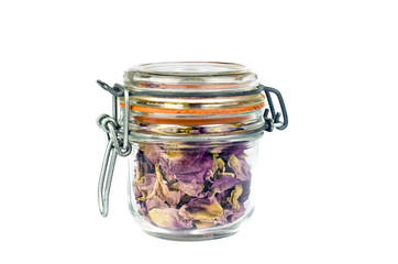 Glass jar full dried wild rose dog-rose petals, isolated