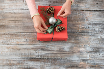 Woman's hands wrapping christmas or other holiday handmade prese
