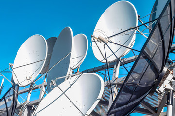 Satellite dish on blue sky background